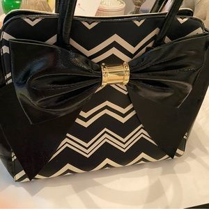 Betsy Johnson black and white bow bag with floral interior
